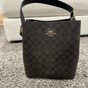 Coach Dark Brown Signature shoulder bucket bag.